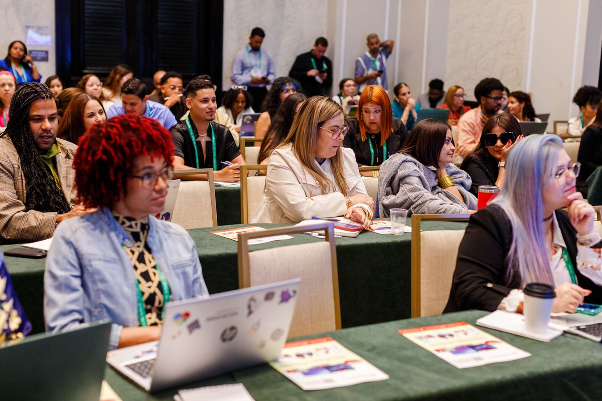 Educators taking notes during a packed session