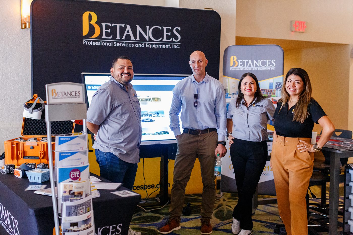 An exhibitor team at their booth in the conference hall