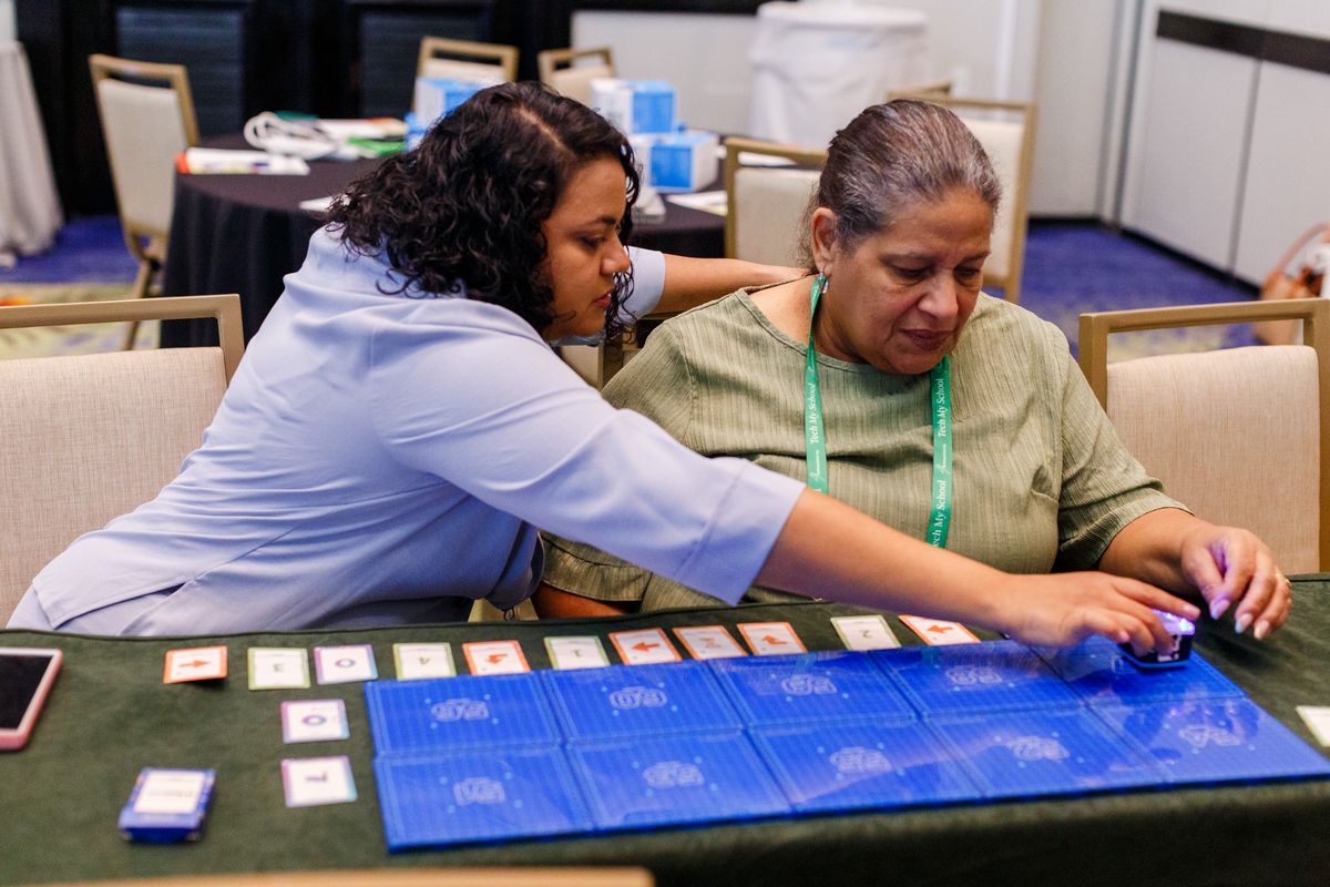 Educators learning to code with KaiBots in a hands-on session