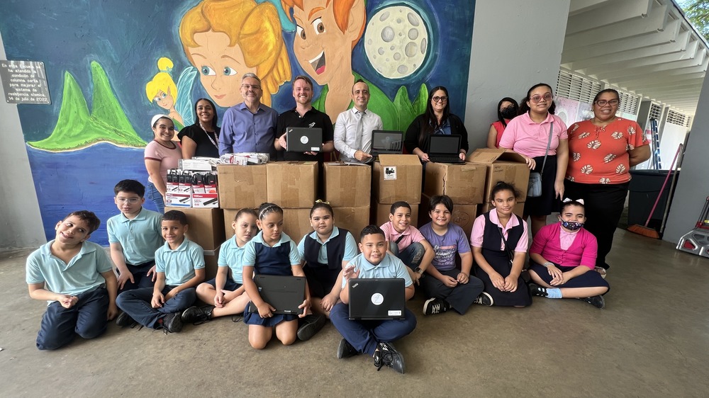 Students with technology donated to their school