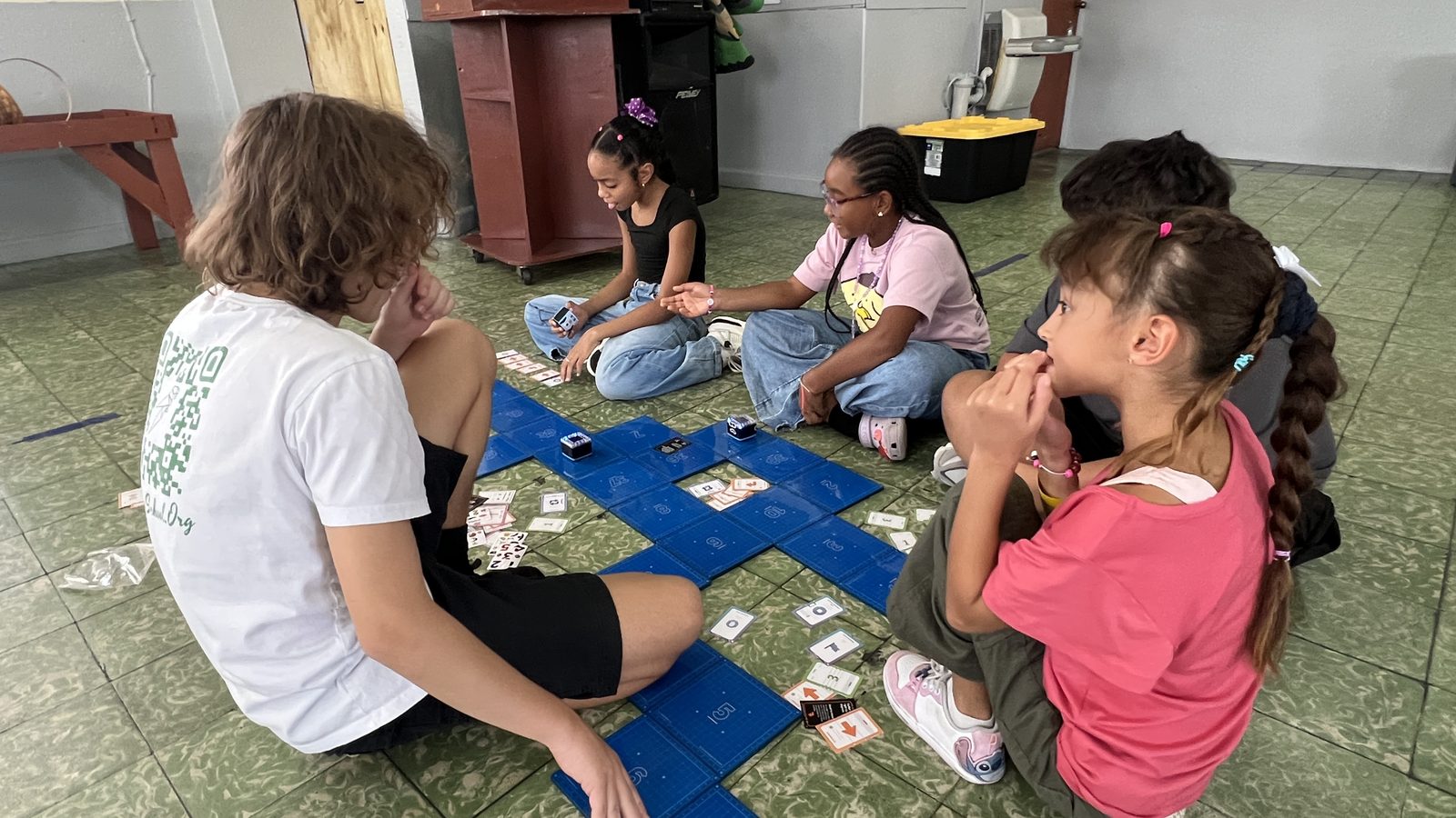 Students learning to code with KaiBot robots and coding cards