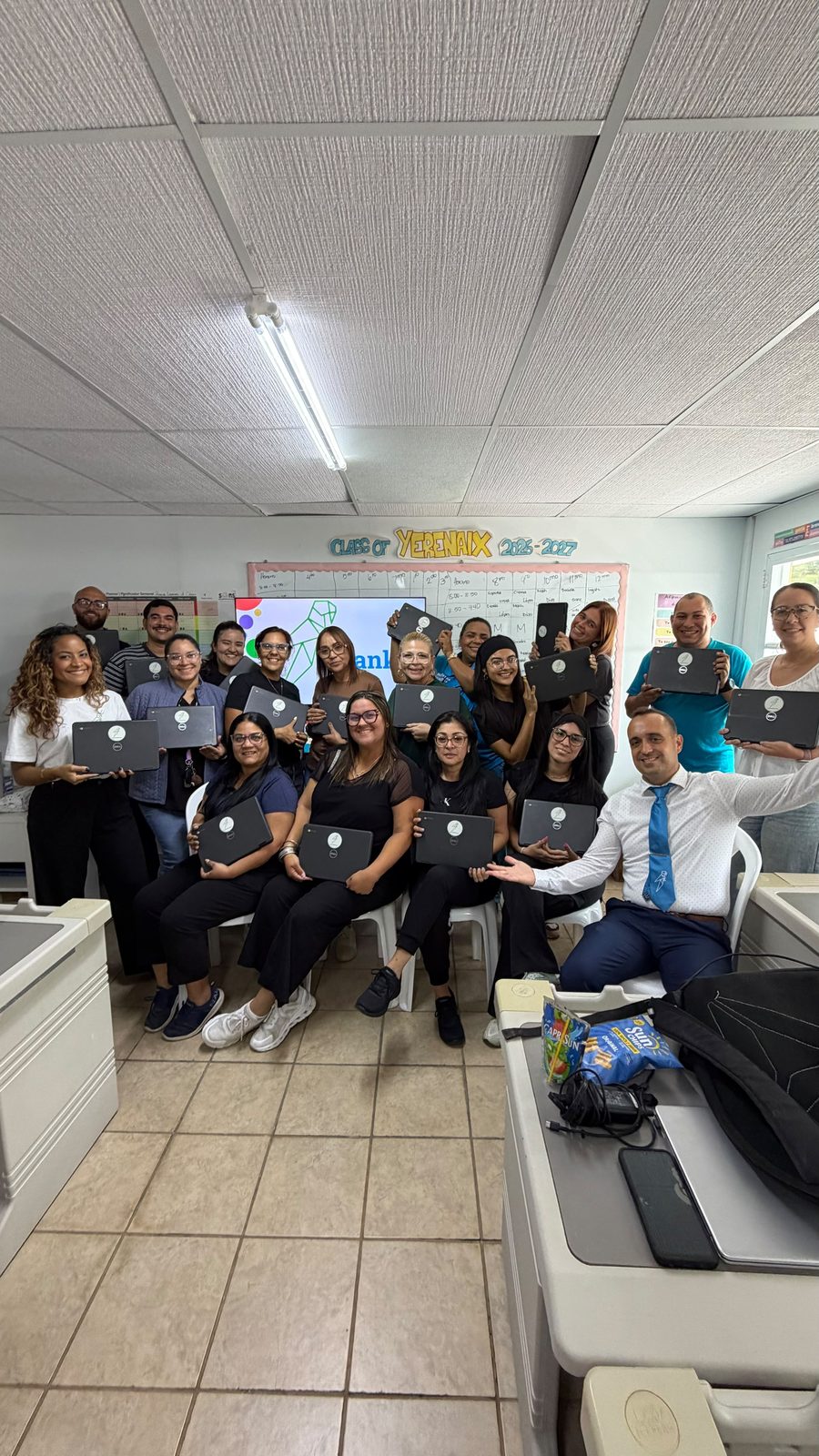 Teachers with donated Chromebooks